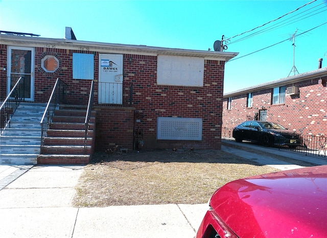 view of front of house featuring brick siding