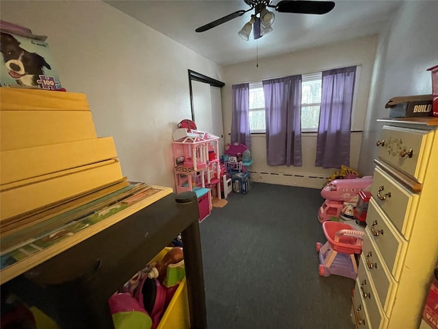 playroom with a baseboard heating unit, carpet, and a ceiling fan