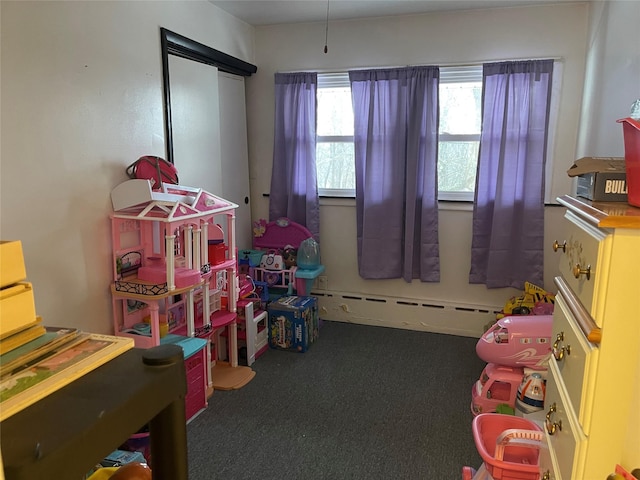 playroom featuring baseboard heating and carpet flooring