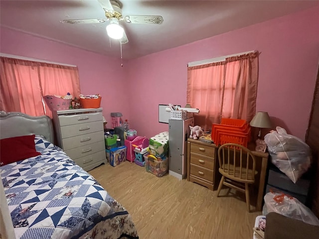 bedroom with light wood-style floors and ceiling fan