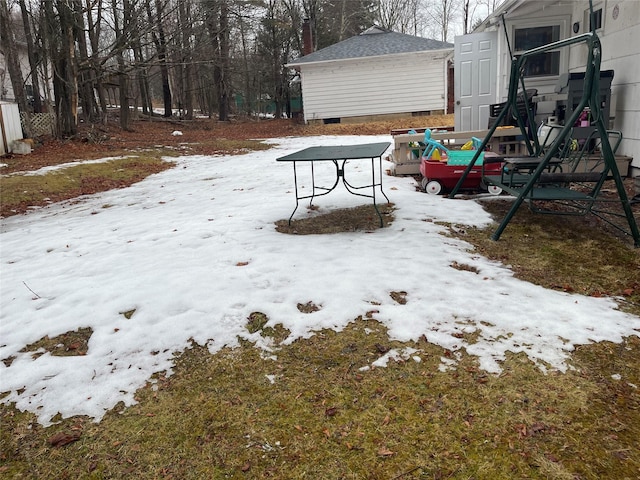 snowy yard featuring an outdoor structure