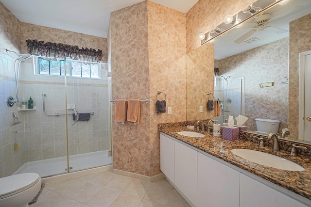 full bath with a sink, toilet, and a shower stall