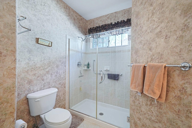 full bathroom with a stall shower and toilet