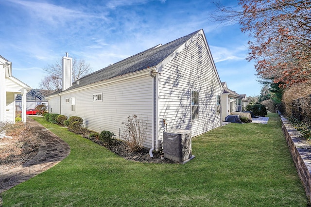 view of property exterior featuring a chimney and a yard