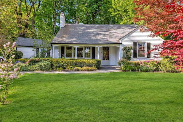 view of front of house featuring a front yard and a chimney