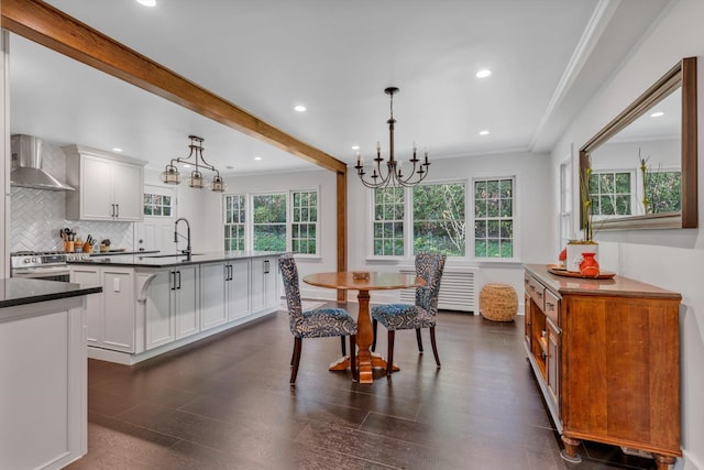 dining space with ornamental molding, dark wood-type flooring, a notable chandelier, beam ceiling, and recessed lighting