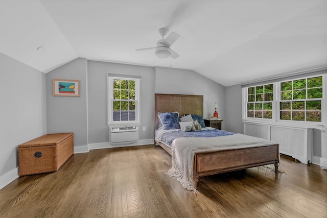 bedroom with lofted ceiling, a ceiling fan, baseboards, radiator, and wood-type flooring