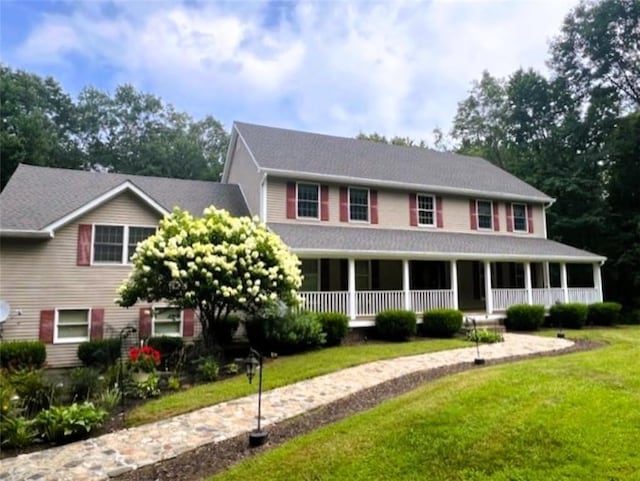 view of front of property with a front yard and covered porch