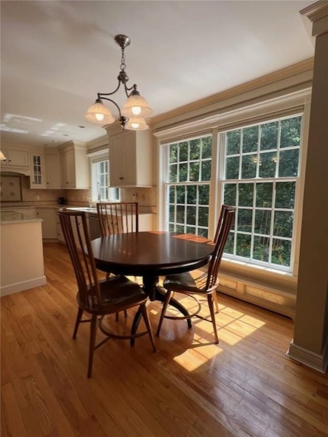 dining area with light wood-style flooring and a chandelier