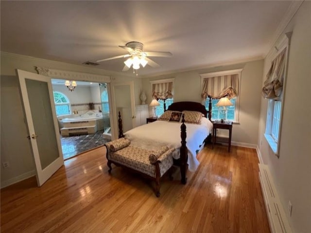 bedroom featuring visible vents, ornamental molding, baseboard heating, and wood finished floors