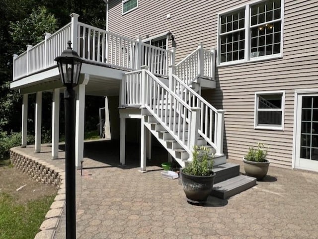 view of patio featuring stairs and a deck