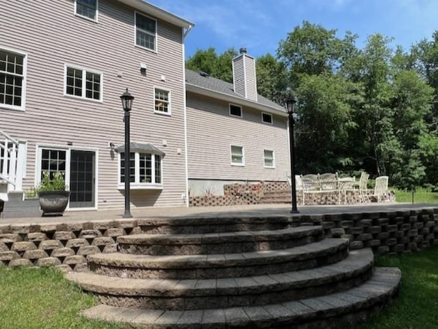 back of property featuring a chimney