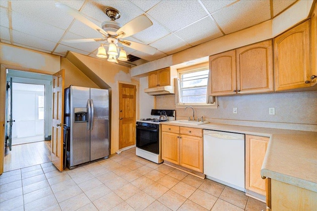 kitchen featuring light countertops, white appliances, a sink, and under cabinet range hood