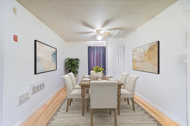 dining area featuring light wood-type flooring, baseboards, and visible vents