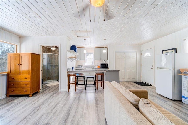 living room featuring wood ceiling and light wood finished floors