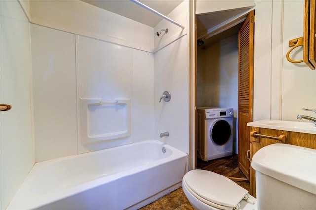 full bath with toilet, washer / dryer, a sink, and shower / bathtub combination