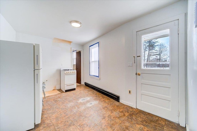 interior space featuring a baseboard radiator and stone finish flooring