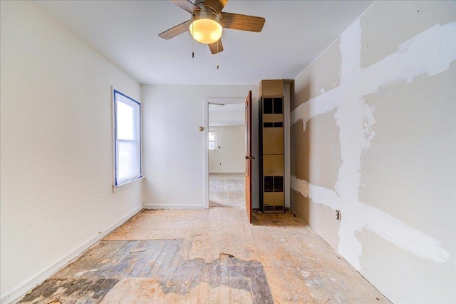 unfurnished room with baseboards