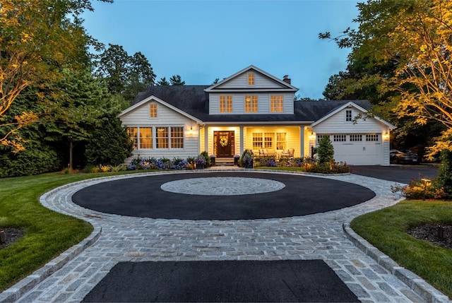 view of front of property featuring a front yard, curved driveway, and a chimney