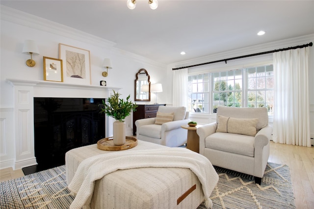 bedroom with ornamental molding, a fireplace, recessed lighting, and light wood-style floors