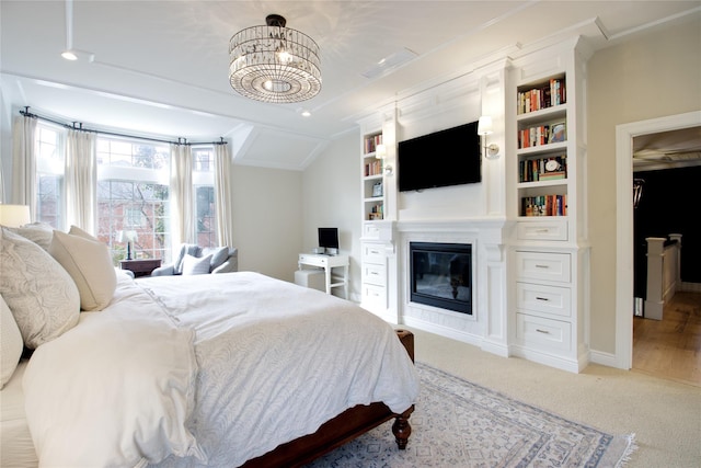 bedroom featuring a glass covered fireplace, light carpet, a notable chandelier, and baseboards