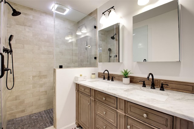 full bathroom featuring double vanity, walk in shower, and a sink