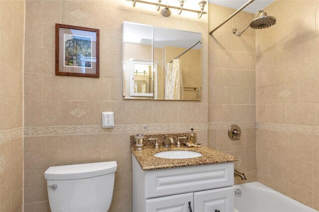 full bathroom featuring shower / tub combo with curtain, tile walls, tasteful backsplash, toilet, and vanity