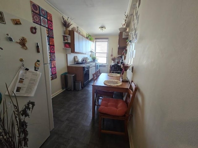 kitchen featuring open shelves, light countertops, and freestanding refrigerator