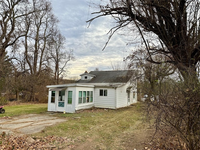 back of property with a lawn