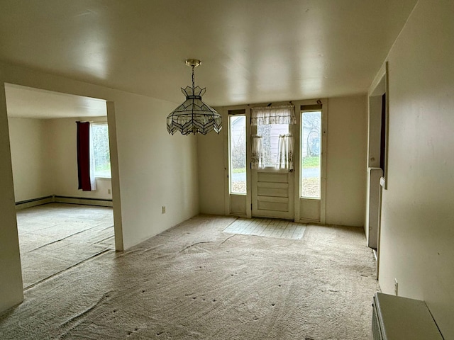 carpeted entryway featuring a healthy amount of sunlight and a baseboard radiator