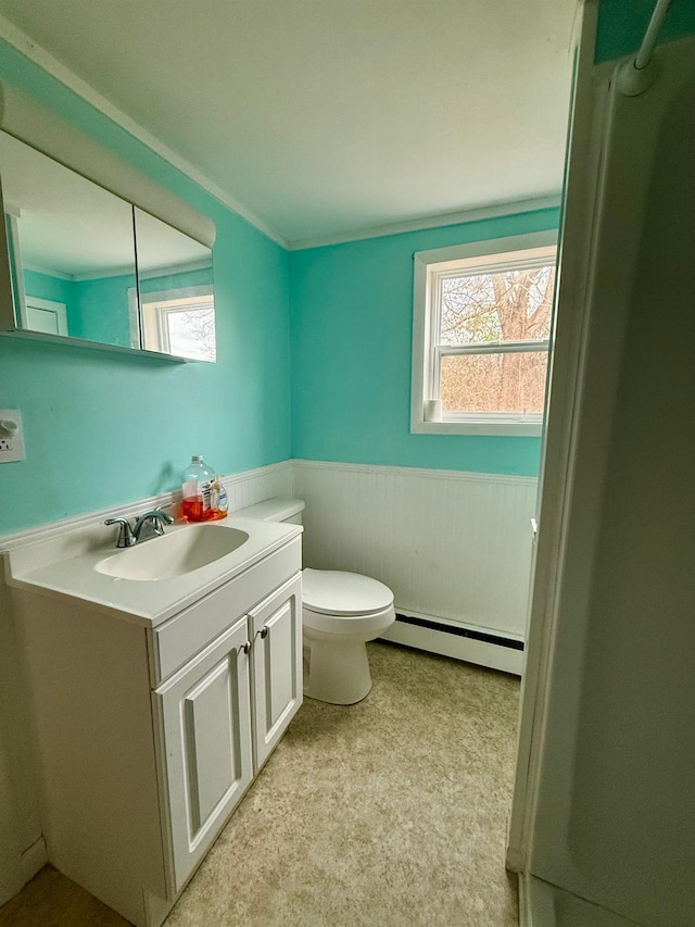 bathroom featuring toilet, a baseboard radiator, vanity, and wainscoting