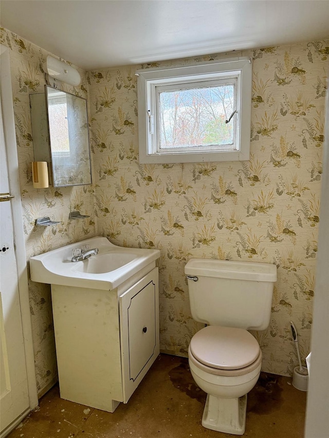 half bathroom with a wealth of natural light and wallpapered walls