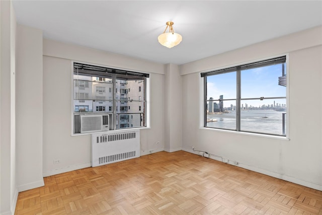 spare room featuring radiator heating unit and baseboards