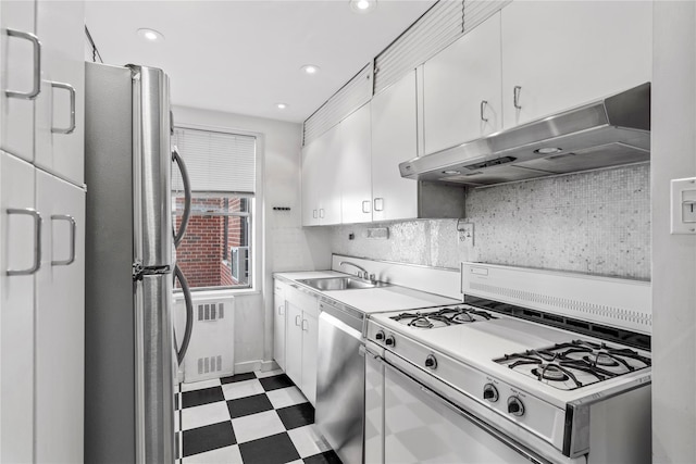 kitchen with under cabinet range hood, light floors, white cabinets, stainless steel appliances, and a sink