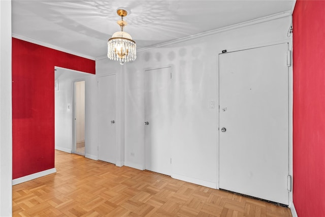 unfurnished bedroom with baseboards, crown molding, and an inviting chandelier