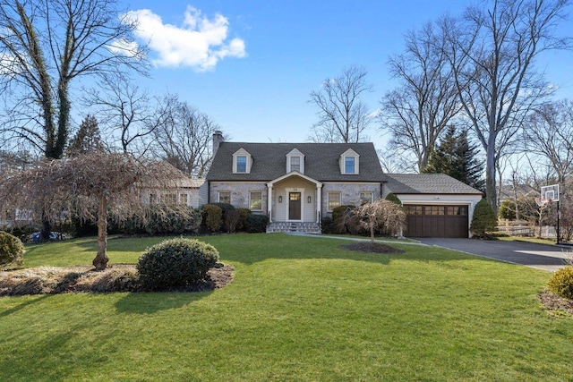 view of front of house featuring aphalt driveway, an attached garage, a front yard, and a chimney