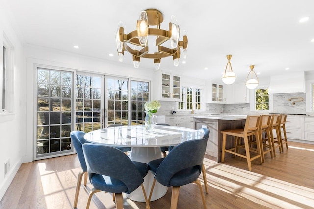 dining room with recessed lighting, visible vents, a healthy amount of sunlight, and light wood-style flooring