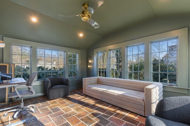 sunroom / solarium featuring a wealth of natural light, ceiling fan, and lofted ceiling