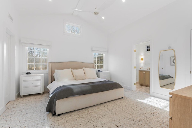 bedroom featuring visible vents, baseboards, carpet floors, ensuite bathroom, and high vaulted ceiling