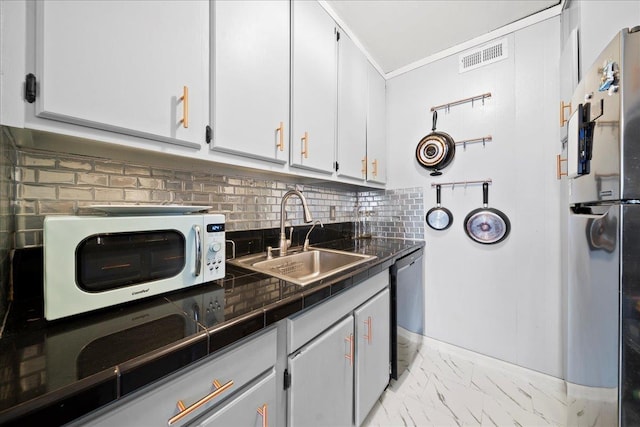 kitchen with dishwasher, white microwave, freestanding refrigerator, marble finish floor, and a sink