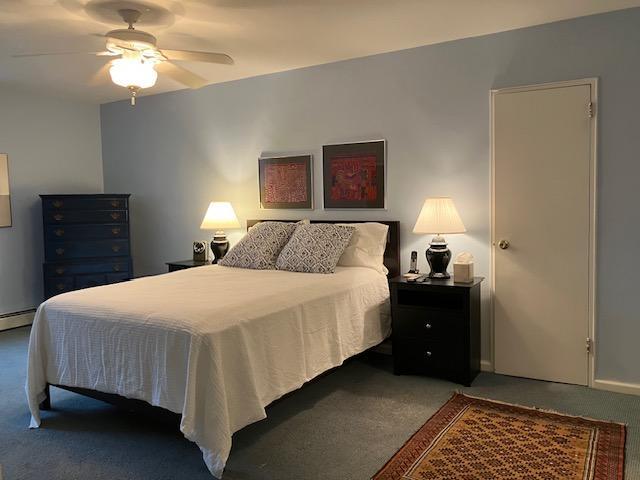 20 Chapel Pl Unit 2K, Great Neck, NY 11021 - carpeted bedroom featuring ceiling fan