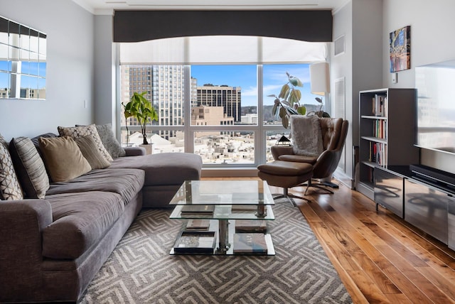 living area with wood finished floors and visible vents