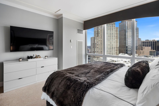 bedroom featuring multiple windows, ornamental molding, a city view, and carpet flooring