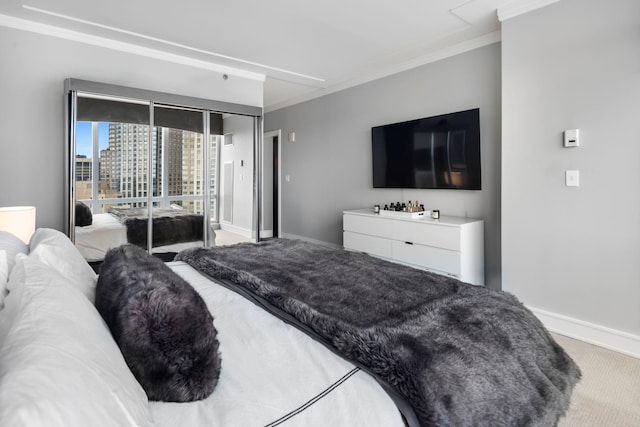 carpeted bedroom featuring baseboards and crown molding