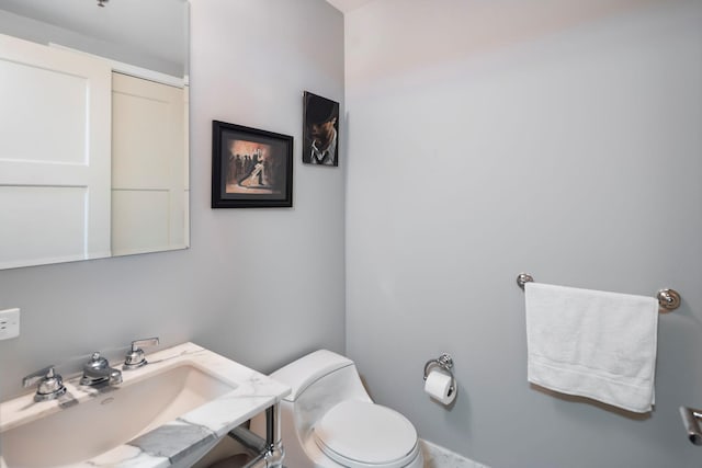 bathroom featuring toilet and a sink