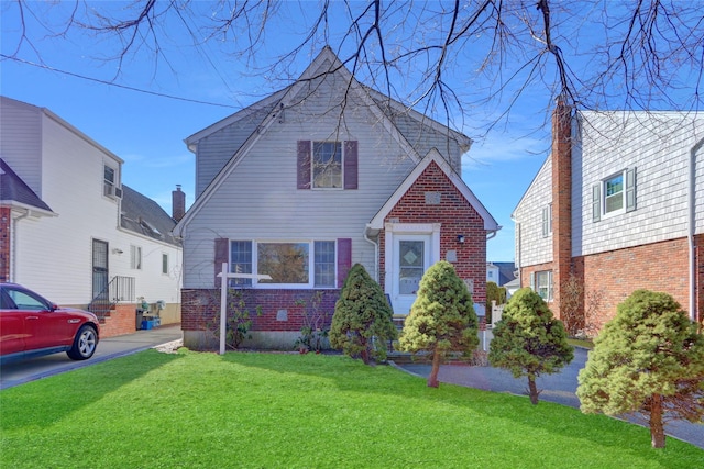 view of front of house with brick siding and a front yard