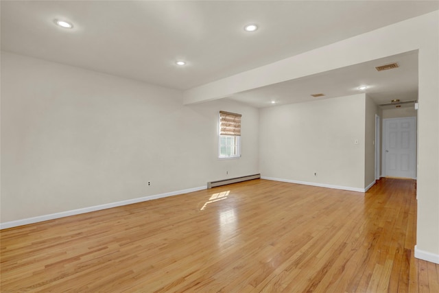 unfurnished room with recessed lighting, visible vents, baseboards, light wood-style floors, and baseboard heating