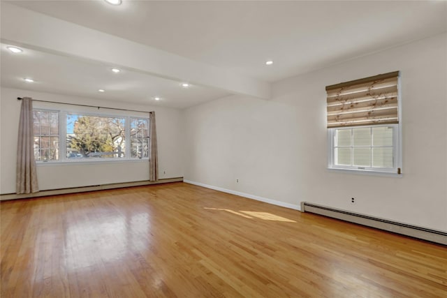 unfurnished room with recessed lighting, baseboard heating, and wood finished floors