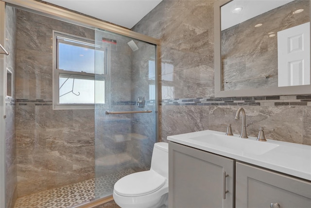 full bathroom with a stall shower, tasteful backsplash, toilet, vanity, and tile walls