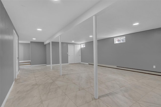 below grade area featuring baseboard heating, recessed lighting, and baseboards